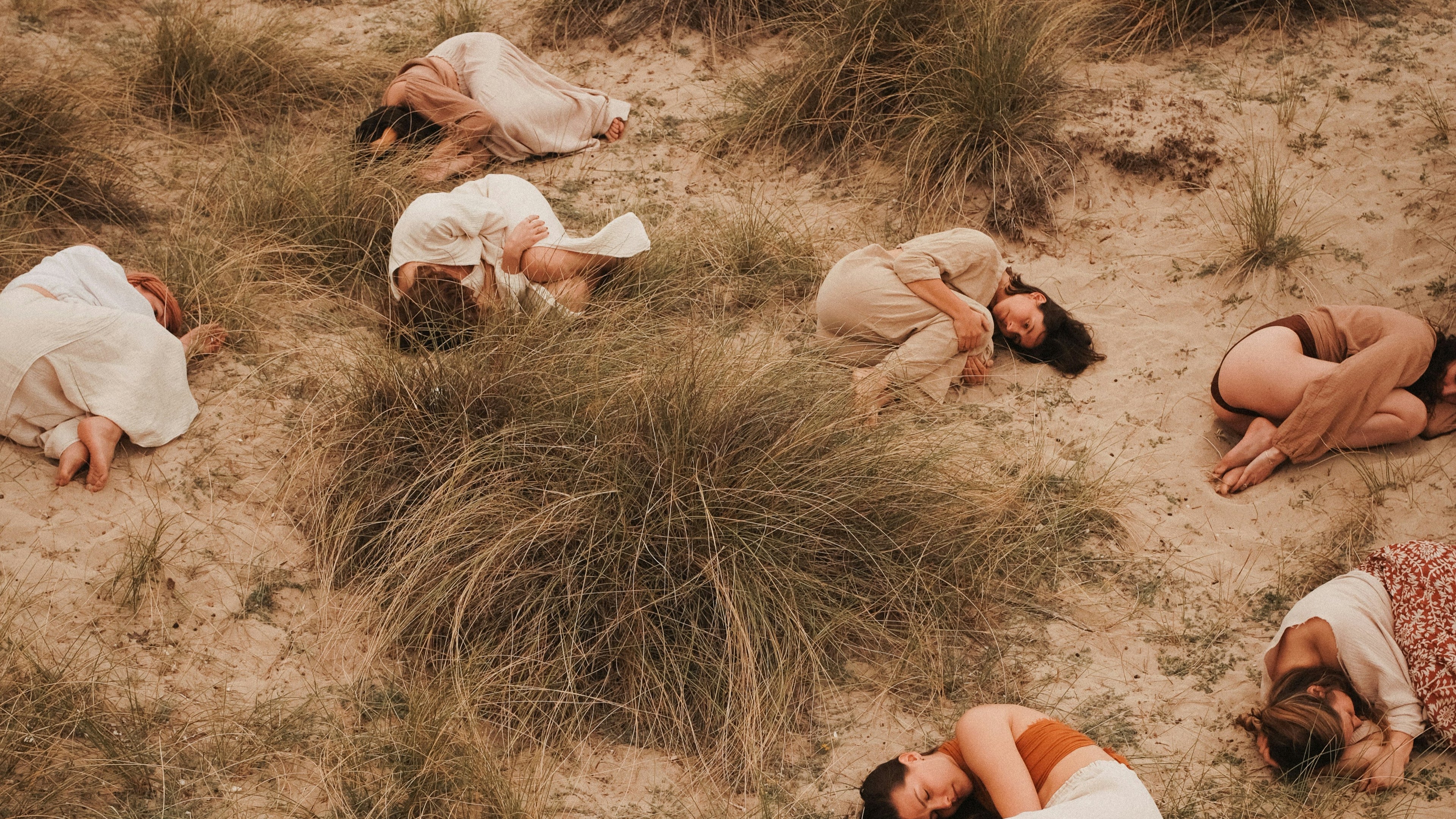 Group of women lying in a circle outdoors, symbolizing sisterhood, perimenopause support, wild yam cream, hormone balance, and relief from vaginal dryness